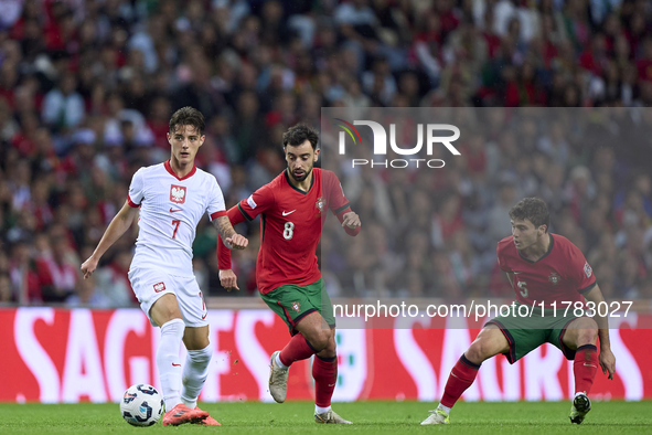 Bruno Fernandes of Portugal competes for the ball with Kacper Urbanski of Poland during the UEFA Nations League 2024/25 League A Group A1 ma...