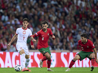 Bruno Fernandes of Portugal competes for the ball with Kacper Urbanski of Poland during the UEFA Nations League 2024/25 League A Group A1 ma...