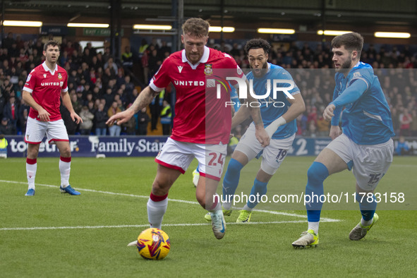 Dan Scarr #24 of Wrexham A.F.C. is challenged by Ethan Pye #15 of Stockport County F.C. during the Sky Bet League 1 match between Stockport...