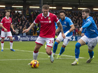 Dan Scarr #24 of Wrexham A.F.C. is challenged by Ethan Pye #15 of Stockport County F.C. during the Sky Bet League 1 match between Stockport...