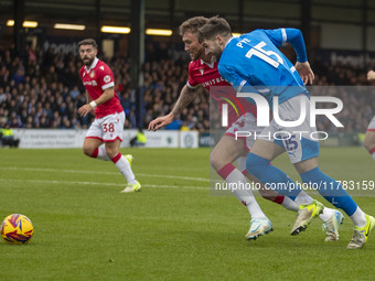 Dan Scarr #24 of Wrexham A.F.C. is challenged by Ethan Pye #15 of Stockport County F.C. during the Sky Bet League 1 match between Stockport...