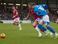 Dan Scarr #24 of Wrexham A.F.C. is challenged by Ethan Pye #15 of Stockport County F.C. during the Sky Bet League 1 match between Stockport...