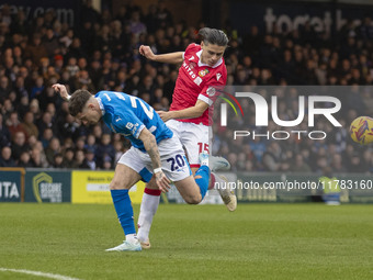 Louie Barry #20 of Stockport County F.C. is challenged by George Dobson #15 of Wrexham A.F.C. during the Sky Bet League 1 match between Stoc...