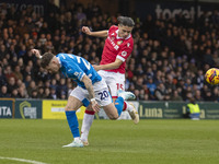 Louie Barry #20 of Stockport County F.C. is challenged by George Dobson #15 of Wrexham A.F.C. during the Sky Bet League 1 match between Stoc...