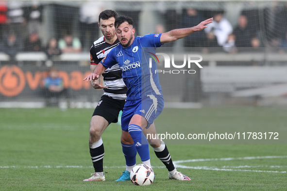 Diego De Girolamo of Buxton is tackled by Toby Lees of Darlington during the Isuzu FA Trophy Second round match between Darlington and Buxto...