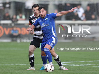 Diego De Girolamo of Buxton is tackled by Toby Lees of Darlington during the Isuzu FA Trophy Second round match between Darlington and Buxto...