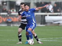 Diego De Girolamo of Buxton is tackled by Toby Lees of Darlington during the Isuzu FA Trophy Second round match between Darlington and Buxto...