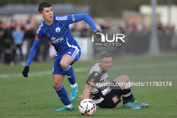 Tom Elliot of Buxton holds off a challenge from Callum Griffiths of Darlington during the Isuzu FA Trophy Second round match between Darling...