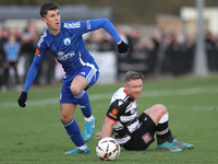 Tom Elliot of Buxton holds off a challenge from Callum Griffiths of Darlington during the Isuzu FA Trophy Second round match between Darling...