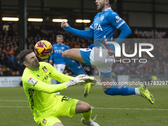 Callum Burton #13 (GK) of Wrexham A.F.C. makes a save during the Sky Bet League 1 match between Stockport County and Wrexham at the Edgeley...