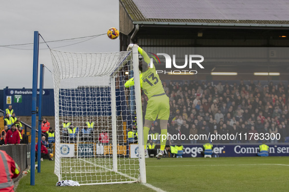 Callum Burton #13 (GK) of Wrexham A.F.C. makes a save during the Sky Bet League 1 match between Stockport County and Wrexham at the Edgeley...