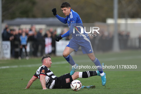 Tom Elliot of Buxton holds off a challenge from Callum Griffiths of Darlington during the Isuzu FA Trophy Second round match between Darling...