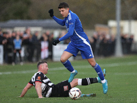 Tom Elliot of Buxton holds off a challenge from Callum Griffiths of Darlington during the Isuzu FA Trophy Second round match between Darling...