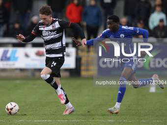 Will Flint of Darlington is challenged by Josh Popoola of Buxton during the Isuzu FA Trophy Second round match between Darlington and Buxton...