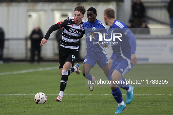 Will Flint of Darlington is challenged by Josh Popoola of Buxton during the Isuzu FA Trophy Second round match between Darlington and Buxton...