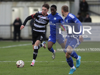 Will Flint of Darlington is challenged by Josh Popoola of Buxton during the Isuzu FA Trophy Second round match between Darlington and Buxton...