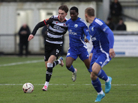 Will Flint of Darlington is challenged by Josh Popoola of Buxton during the Isuzu FA Trophy Second round match between Darlington and Buxton...