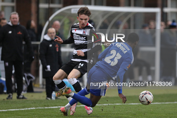 Will Flint of Darlington is challenged by Josh Popoola of Buxton during the Isuzu FA Trophy Second round match between Darlington and Buxton...