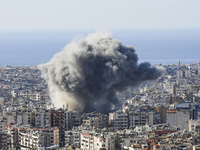 Black smoke rises among the residential buildings following an Israeli airstrike on the Dahieh area in the south of Beirut, Lebanon, on Nove...