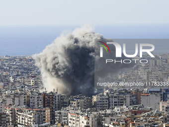 Black smoke rises among the residential buildings following an Israeli airstrike on the Dahieh area in the south of Beirut, Lebanon, on Nove...