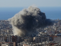 Black smoke rises among the residential buildings following an Israeli airstrike on the Dahieh area in the south of Beirut, Lebanon, on Nove...