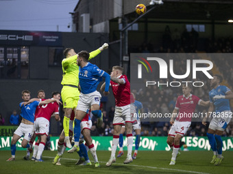 Callum Burton #13 (GK) of Wrexham A.F.C. makes a save during the Sky Bet League 1 match between Stockport County and Wrexham at the Edgeley...