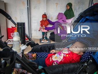 A child is measured during a child stunting prevention program at an integrated services post (POSYANDU) at Perum Panorama Asri in Kalongan...