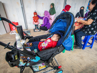 A child is measured during a child stunting prevention program at an integrated services post (POSYANDU) at Perum Panorama Asri in Kalongan...