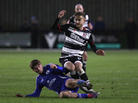 Cian Coleman of Buxton tackles Jarrett Rivers of Darlington during the Isuzu FA Trophy Second round match between Darlington and Buxton at B...