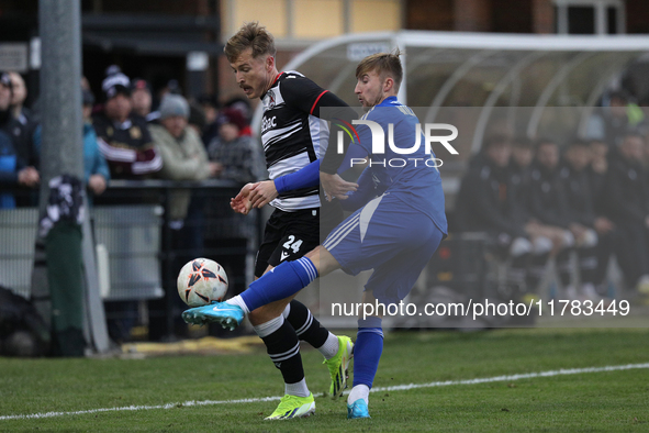 Cameron Salkeld of Darlington is challenged by Josh Williams of Buxton during the Isuzu FA Trophy Second round match between Darlington and...