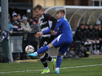 Cameron Salkeld of Darlington is challenged by Josh Williams of Buxton during the Isuzu FA Trophy Second round match between Darlington and...