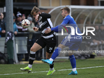 Cameron Salkeld of Darlington is challenged by Josh Williams of Buxton during the Isuzu FA Trophy Second round match between Darlington and...