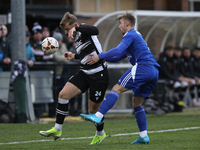 Cameron Salkeld of Darlington is challenged by Josh Williams of Buxton during the Isuzu FA Trophy Second round match between Darlington and...