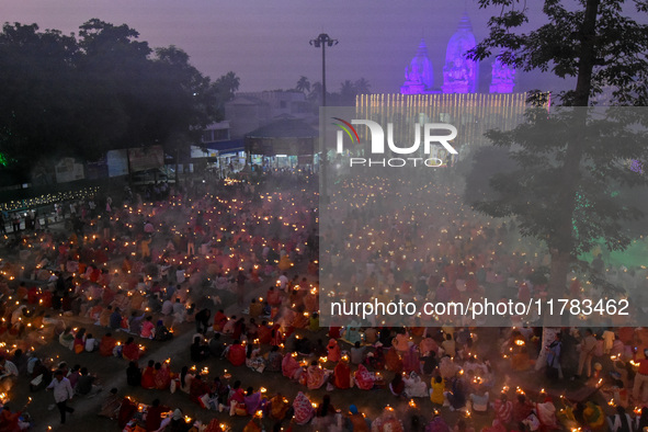 Devotees offer prayers by lighting oil lamps and incense sticks to Sri Loknath Brahmachari on the occasion of Karthik Brata at a Loknath Bra...