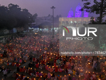 Devotees offer prayers by lighting oil lamps and incense sticks to Sri Loknath Brahmachari on the occasion of Karthik Brata at a Loknath Bra...