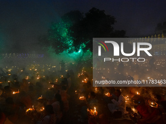 Devotees offer prayers by lighting oil lamps and incense sticks to Sri Loknath Brahmachari on the occasion of Karthik Brata at a Loknath Bra...