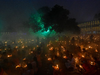 Devotees offer prayers by lighting oil lamps and incense sticks to Sri Loknath Brahmachari on the occasion of Karthik Brata at a Loknath Bra...