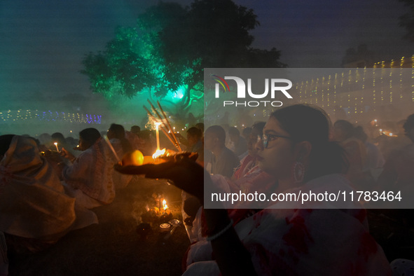 Devotees offer prayers by lighting oil lamps and incense sticks to Sri Loknath Brahmachari on the occasion of Karthik Brata at a Loknath Bra...