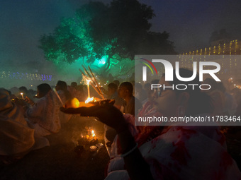 Devotees offer prayers by lighting oil lamps and incense sticks to Sri Loknath Brahmachari on the occasion of Karthik Brata at a Loknath Bra...