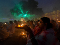 Devotees offer prayers by lighting oil lamps and incense sticks to Sri Loknath Brahmachari on the occasion of Karthik Brata at a Loknath Bra...