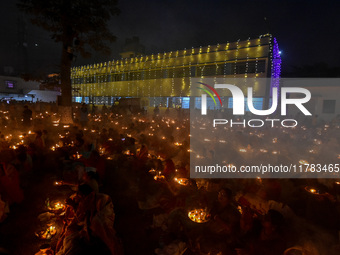 Devotees offer prayers by lighting oil lamps and incense sticks to Sri Loknath Brahmachari on the occasion of Karthik Brata at a Loknath Bra...