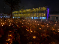 Devotees offer prayers by lighting oil lamps and incense sticks to Sri Loknath Brahmachari on the occasion of Karthik Brata at a Loknath Bra...