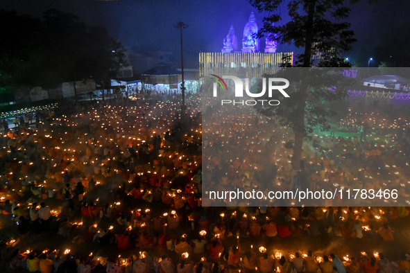 Devotees offer prayers by lighting oil lamps and incense sticks to Sri Loknath Brahmachari on the occasion of Karthik Brata at a Loknath Bra...