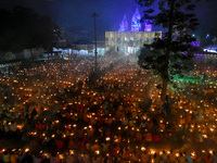 Devotees offer prayers by lighting oil lamps and incense sticks to Sri Loknath Brahmachari on the occasion of Karthik Brata at a Loknath Bra...