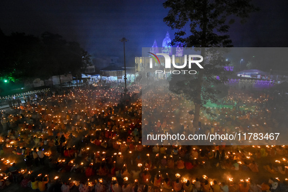 Devotees offer prayers by lighting oil lamps and incense sticks to Sri Loknath Brahmachari on the occasion of Karthik Brata at a Loknath Bra...