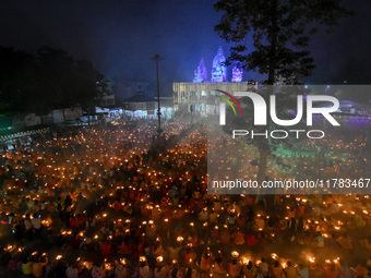 Devotees offer prayers by lighting oil lamps and incense sticks to Sri Loknath Brahmachari on the occasion of Karthik Brata at a Loknath Bra...