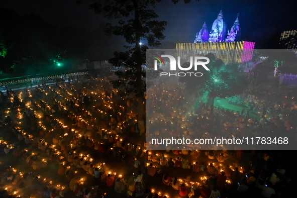 Devotees offer prayers by lighting oil lamps and incense sticks to Sri Loknath Brahmachari on the occasion of Karthik Brata at a Loknath Bra...