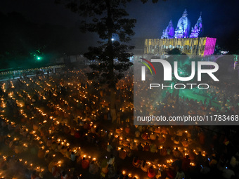 Devotees offer prayers by lighting oil lamps and incense sticks to Sri Loknath Brahmachari on the occasion of Karthik Brata at a Loknath Bra...