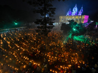 Devotees offer prayers by lighting oil lamps and incense sticks to Sri Loknath Brahmachari on the occasion of Karthik Brata at a Loknath Bra...