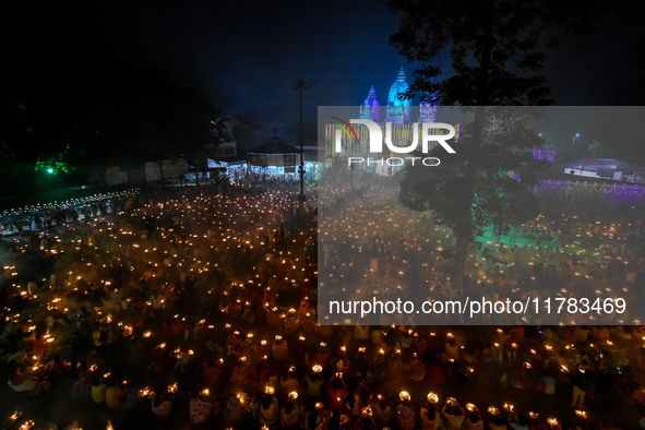 Devotees offer prayers by lighting oil lamps and incense sticks to Sri Loknath Brahmachari on the occasion of Karthik Brata at a Loknath Bra...